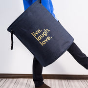 Holding a Navy Linen Fabric Live,Laugh,Love Laundry Basket