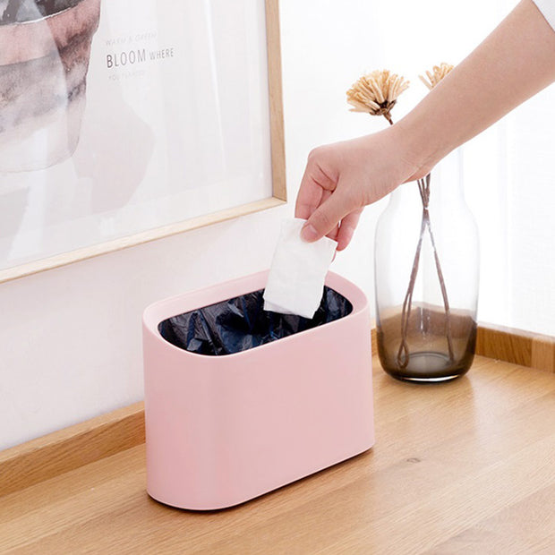 Throwing Tissue into Pink Mini Table Top Waste Bin