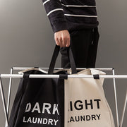 Holding a Black/Beige 2 Tier Dark & Light Laundry Rack