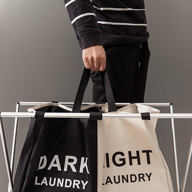 Holding a Black/Beige 2 Tier Dark & Light Laundry Rack